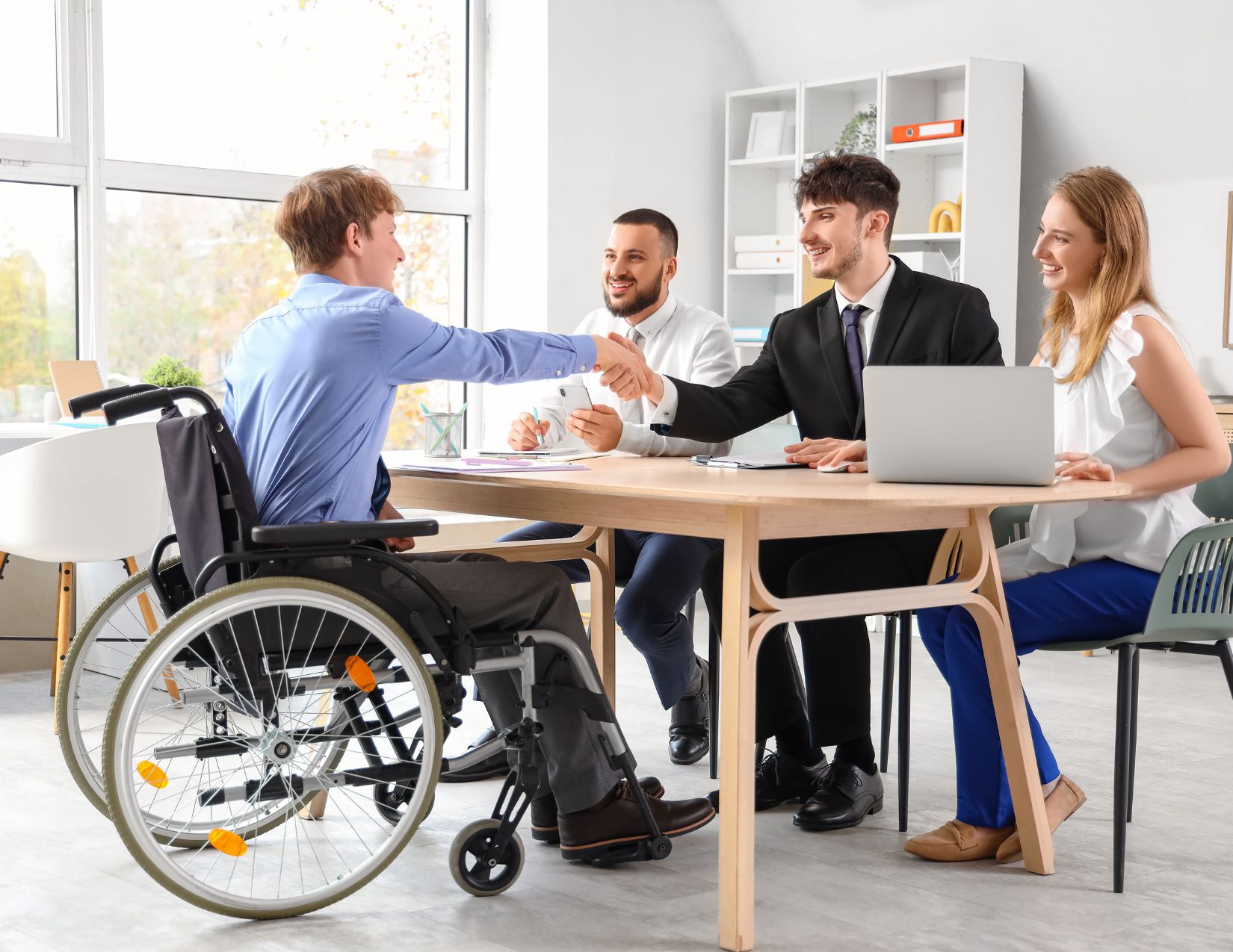 Young man in wheelchair receiving project support